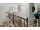 Upstairs hallway with iron railing and doors at 10 Toscanno Dr, Covington, GA 30014