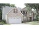 Brick house with a two-car garage and landscaped lawn at 4768 Redbranch Rd, Decatur, GA 30035
