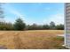 Large backyard with small patio and treeline view at 3170 Fareed St, Douglasville, GA 30135