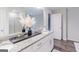 Double vanity bathroom with granite countertops and large mirror at 3170 Fareed St, Douglasville, GA 30135