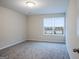 Bright bedroom with neutral carpeting and large windows at 3170 Fareed St, Douglasville, GA 30135