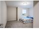 Bright bedroom with carpeted floor and floral bedding at 3170 Fareed St, Douglasville, GA 30135