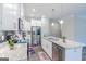 Modern kitchen with white cabinets, granite island, and stainless steel appliances at 3170 Fareed St, Douglasville, GA 30135