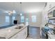 Modern kitchen with white cabinets, granite island, and stainless steel appliances at 3170 Fareed St, Douglasville, GA 30135