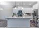 Modern kitchen with white cabinets, granite island, and stainless steel appliances at 3170 Fareed St, Douglasville, GA 30135