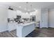 Modern kitchen with white cabinets, granite island, and stainless steel appliances at 3170 Fareed St, Douglasville, GA 30135