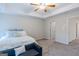 Main bedroom with ceiling fan, carpet flooring, and ensuite bathroom at 3170 Fareed St, Douglasville, GA 30135