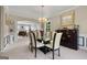 Bright dining room with a glass-top table and access to the kitchen at 1425 Ethans Way, Mcdonough, GA 30252