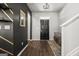 Modern entryway with dark walls, wood floors, and a bench at 1752 Alford Dr, Jonesboro, GA 30236