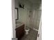 A bathroom that contains a shower, a toilet, and a sink with a mirror at 1810 Highway 138 E, Stockbridge, GA 30281
