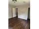 A bedroom with wood floors and an entrance to a closet at 1810 Highway 138 E, Stockbridge, GA 30281