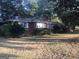 Brick ranch house with mature trees and a large yard at 1810 Highway 138 E, Stockbridge, GA 30281