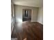 A living room with wood floors, a window with blinds, and an arched doorway at 1810 Highway 138 E, Stockbridge, GA 30281