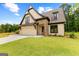 Craftsman style home with stone accents and a 3-car garage at 210 Regester Way # 42, Peachtree City, GA 30269