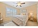 Bright bedroom with a queen-size bed, window shutters, and ceiling fan at 300 South Village Sq, Canton, GA 30115