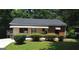 Quaint, one-story bungalow with a red brick accent and well-manicured front yard at 1551 Ferno Nw Dr, Atlanta, GA 30318