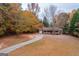 House with driveway, surrounded by colorful autumn trees at 2949 Hog Mountain Rd, Dacula, GA 30019