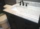 Modern bathroom vanity with marble countertop and dark cabinets at 4490 Latchwood Dr, Lithonia, GA 30038