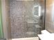 Modern bathroom with a pebble tile shower and gray tile at 4490 Latchwood Dr, Lithonia, GA 30038