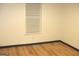 Simple bedroom with wood flooring and a window with blinds at 4490 Latchwood Dr, Lithonia, GA 30038