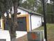 Attached garage with black door and wood accent at 4490 Latchwood Dr, Lithonia, GA 30038