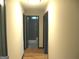 Hallway with wood floors and doors to bathroom and other rooms at 4490 Latchwood Dr, Lithonia, GA 30038