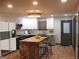 Modern kitchen with white and black cabinets and a herringbone island at 4490 Latchwood Dr, Lithonia, GA 30038