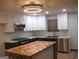 Modern kitchen featuring white cabinets, marble countertops, and a herringbone island at 4490 Latchwood Dr, Lithonia, GA 30038