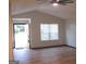 Spacious living room with vaulted ceiling, wood-look floors, and front door view at 4490 Latchwood Dr, Lithonia, GA 30038