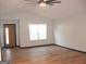 Bright living room with vaulted ceiling, wood-look floors, and large window at 4490 Latchwood Dr, Lithonia, GA 30038