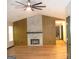 Living room with a fireplace and wood-like accent wall at 4490 Latchwood Dr, Lithonia, GA 30038