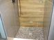 Spa-like shower with pebble floor and wood-look tile at 4490 Latchwood Dr, Lithonia, GA 30038