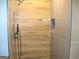 Modern shower with wood-look tile and pebble floor at 4490 Latchwood Dr, Lithonia, GA 30038