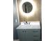 Modern bathroom vanity with round mirror and white countertop at 4490 Latchwood Dr, Lithonia, GA 30038