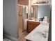 Bathroom with shower, vanity, and wood cabinets at 4767 Glenwhite Dr, Duluth, GA 30096