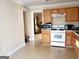 Kitchen with gas range, microwave, and wood cabinets at 4767 Glenwhite Dr, Duluth, GA 30096