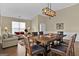 Open dining area with a rustic wooden table and leather chairs at 701 Brambling Way, Stockbridge, GA 30281