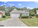 Ranch-style home with two-car garage and landscaped lawn at 701 Brambling Way, Stockbridge, GA 30281