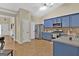 Modern kitchen with blue cabinets, stainless steel appliances and hardwood floors at 701 Brambling Way, Stockbridge, GA 30281