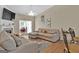 Relaxing living room with sectional sofa, hardwood floors, and fireplace at 701 Brambling Way, Stockbridge, GA 30281