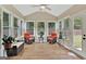 Bright sunroom with wicker chairs and access to backyard at 701 Brambling Way, Stockbridge, GA 30281