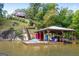 Lakefront home with a dock, boat lift, and relaxing seating area at 440 Yancey Cir, Covington, GA 30014