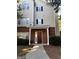 Tan siding two story home with a brown front door at 101 Spring Heights Ln, Smyrna, GA 30080