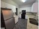 Kitchen with granite counters, white cabinets, and appliances at 101 Spring Heights Ln, Smyrna, GA 30080