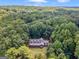 Aerial view of a house nestled in a wooded area at 95 Fern Ct, Stockbridge, GA 30281