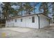 White brick house back with a patio and wooden fence at 3893 Bonnie Se Ln, Atlanta, GA 30354