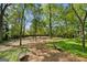 Spacious backyard with lush trees and brick pathway at 3115 Pennington Sw St, Covington, GA 30014