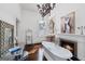 Elegant bathroom featuring a freestanding tub, fireplace, and ornate chandelier at 3115 Pennington Sw St, Covington, GA 30014