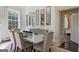 Elegant dining room with a white table, tufted banquettes, and decorative mirrors at 3115 Pennington Sw St, Covington, GA 30014