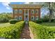 Grand brick home with boxwood hedges and brick pathway at 3115 Pennington Sw St, Covington, GA 30014